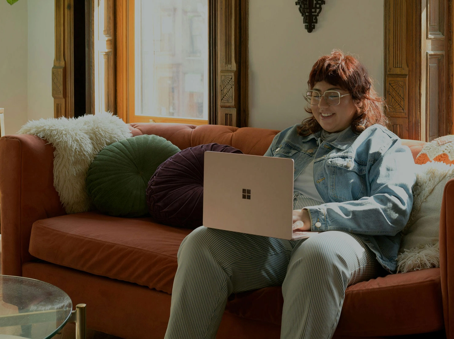 Person using laptop on couch